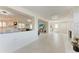 Spacious living room with a wall-mounted TV and open access to the kitchen and other living spaces at 726 Jungle Queen Way, Longboat Key, FL 34228