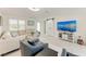 Bright living room with sleek furniture, a sliding barn door, and entertainment center at 726 Jungle Queen Way, Longboat Key, FL 34228
