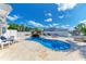 Beautiful pool area with a waterfall feature, lounge chairs, and a well-maintained patio at 726 Jungle Queen Way, Longboat Key, FL 34228