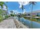 Picturesque waterfront scene with a paver patio, dock access, and tranquil canal views, perfect for boating enthusiasts at 726 Jungle Queen Way, Longboat Key, FL 34228