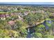 Aerial view of the community's lush landscape, waterways and golf course creating an active lifestyle at 7674 Fairway Woods Dr # 1605, Sarasota, FL 34238