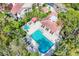 Aerial view of community pool and hot tub surrounded by lush tropical landscaping at 7674 Fairway Woods Dr # 1605, Sarasota, FL 34238