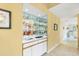 Elegant bar area featuring mirrored backsplash, ample storage, and a convenient sink at 7674 Fairway Woods Dr # 1605, Sarasota, FL 34238