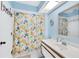Bathroom with a blue wall, a single sink, and a shower-tub combo at 7674 Fairway Woods Dr # 1605, Sarasota, FL 34238