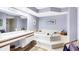 Large bathroom with a sunken tub, a neutral color palette, and great lighting at 7674 Fairway Woods Dr # 1605, Sarasota, FL 34238