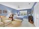 Bedroom featuring blue walls, neutral carpeting, and a ceiling fan at 7674 Fairway Woods Dr # 1605, Sarasota, FL 34238