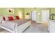 Bedroom features neutral carpeting, a large bed, and a view into the en suite bathroom at 7674 Fairway Woods Dr # 1605, Sarasota, FL 34238