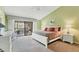 Bright bedroom features a sliding glass door to a balcony and neutral carpeting at 7674 Fairway Woods Dr # 1605, Sarasota, FL 34238