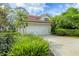 Charming home featuring a two-car garage, well-manicured landscaping, and a classic tile roof at 7674 Fairway Woods Dr # 1605, Sarasota, FL 34238