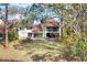 View of the exterior with large grassy backyard and screened in lanai at 7674 Fairway Woods Dr # 1605, Sarasota, FL 34238