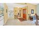 Inviting foyer featuring tile flooring, a wooden front door, and a decorative mirror at 7674 Fairway Woods Dr # 1605, Sarasota, FL 34238