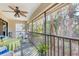 Relaxing screened lanai with a ceiling fan and lovely view of lush greenery at 7674 Fairway Woods Dr # 1605, Sarasota, FL 34238