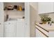 Laundry room featuring side-by-side appliances and shelving at 7674 Fairway Woods Dr # 1605, Sarasota, FL 34238