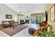 Spacious living room with tile flooring, a fireplace, and comfortable leather seating at 7674 Fairway Woods Dr # 1605, Sarasota, FL 34238