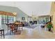 Bright living space combining living room and dining area, with a fireplace and a balcony view at 7674 Fairway Woods Dr # 1605, Sarasota, FL 34238