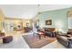 Open living room showcasing the dining area, neutral tile floors, and a comfortable seating arrangement at 7674 Fairway Woods Dr # 1605, Sarasota, FL 34238