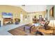 Spacious living area with a TV, tile flooring, and a dining area perfect for entertaining guests at 7674 Fairway Woods Dr # 1605, Sarasota, FL 34238