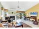 Inviting living room featuring a fireplace, neutral tile floors, and sliding doors to the outdoor balcony at 7674 Fairway Woods Dr # 1605, Sarasota, FL 34238