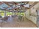 Spacious outdoor kitchen with stainless steel appliances and ample seating under a vaulted ceiling at 7674 Fairway Woods Dr # 1605, Sarasota, FL 34238