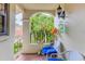 Cozy outdoor patio featuring tile flooring, an arched wall design, and comfortable seating with blue cushions at 7674 Fairway Woods Dr # 1605, Sarasota, FL 34238