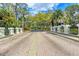 Charming brick-paved street lined with lush trees and decorative posts in a welcoming neighborhood setting at 7674 Fairway Woods Dr # 1605, Sarasota, FL 34238