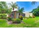 A view of the screened-in lanai with lush landscaping and palm trees at 814 Spring Lakes Blvd # 14, Bradenton, FL 34210