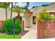 Charming courtyard entrance with lattice, palm trees, and a well-maintained walkway to the front door at 814 Spring Lakes Blvd # 14, Bradenton, FL 34210