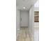 Inviting hallway with light wood floors and a view of the front door and a screened window at 814 Spring Lakes Blvd # 14, Bradenton, FL 34210
