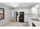 Clean kitchen with stainless steel appliances, white cabinets, and a window at 814 Spring Lakes Blvd # 14, Bradenton, FL 34210