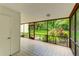 Spacious screened lanai with tile flooring and views of the lush garden and tropical landscaping at 814 Spring Lakes Blvd # 14, Bradenton, FL 34210