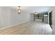 Bright and airy living room featuring light floors, large windows, and modern lighting fixtures at 814 Spring Lakes Blvd # 14, Bradenton, FL 34210