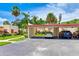 Carport parking with mature trees, colorful landscaping, and well-maintained lawn at 814 Spring Lakes Blvd # 14, Bradenton, FL 34210