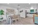 Open-concept dining area with modern decor, stainless steel appliances and white cabinets at 946 Charlotte Ave, Sarasota, FL 34237
