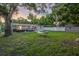 Full backyard view of lawn, dining furniture, lounge furniture, shed, and privacy fence at 946 Charlotte Ave, Sarasota, FL 34237
