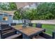 Landscaped backyard with dining table, sculpture, lush lawn, and privacy fence at 946 Charlotte Ave, Sarasota, FL 34237