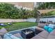 Spacious backyard with lounge seating, a hammock, mature trees, and privacy fence at 946 Charlotte Ave, Sarasota, FL 34237