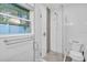 Clean bathroom with a glass shower enclosure, white tile, and a modern toilet at 946 Charlotte Ave, Sarasota, FL 34237