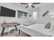 Well-lit bedroom featuring a clean white comforter, dragonfly decoration, and modern decor at 946 Charlotte Ave, Sarasota, FL 34237