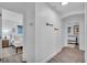 Bright hallway featuring wood-look flooring and decorative arrow wall hangings, leading to bedrooms at 946 Charlotte Ave, Sarasota, FL 34237