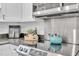 Modern kitchen featuring stainless steel microwave, electric range, and granite countertops at 946 Charlotte Ave, Sarasota, FL 34237