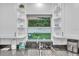 Stylish kitchen showcasing granite counters, white cabinets and view of the backyard with hammock at 946 Charlotte Ave, Sarasota, FL 34237