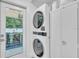 Convenient laundry area with stacked washer and dryer units, plus views of the outdoor dining area at 946 Charlotte Ave, Sarasota, FL 34237