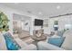 Inviting living room featuring comfortable seating, a TV, and sliding barn doors at 946 Charlotte Ave, Sarasota, FL 34237