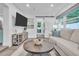 Cozy living room with modern decor, a flat-screen TV, and a view of the backyard at 946 Charlotte Ave, Sarasota, FL 34237