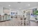 Open-concept living and dining area with wood floors and modern furnishings at 946 Charlotte Ave, Sarasota, FL 34237
