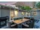 Outdoor patio featuring a dining table and wicker seating area under a sunshade at 946 Charlotte Ave, Sarasota, FL 34237