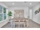 Dining room area with gray floors, a wooden table with six chairs, and a picturesque window at 946 Charlotte Ave, Sarasota, FL 34237