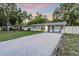Charming single-story home with a gravel driveway, lush trees, and well-kept lawn at 946 Charlotte Ave, Sarasota, FL 34237