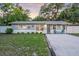 Charming single-story home featuring a well-maintained front lawn and gravel driveway at 946 Charlotte Ave, Sarasota, FL 34237