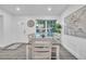 Bright dining room featuring a wooden table, six chairs, gray floors, and natural light at 946 Charlotte Ave, Sarasota, FL 34237